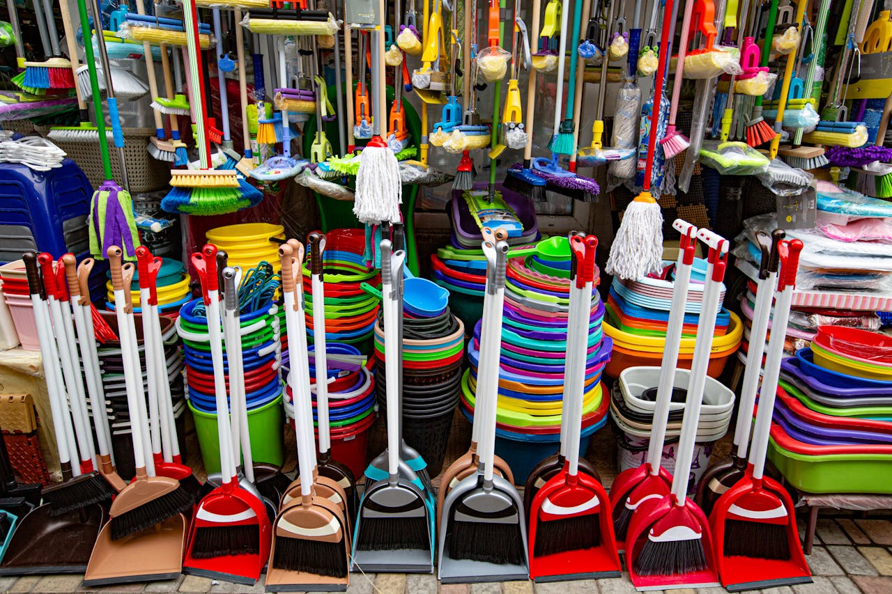 why-choose-us From above various sets of broom and scoop placed in household goods store near colorful basins and bins