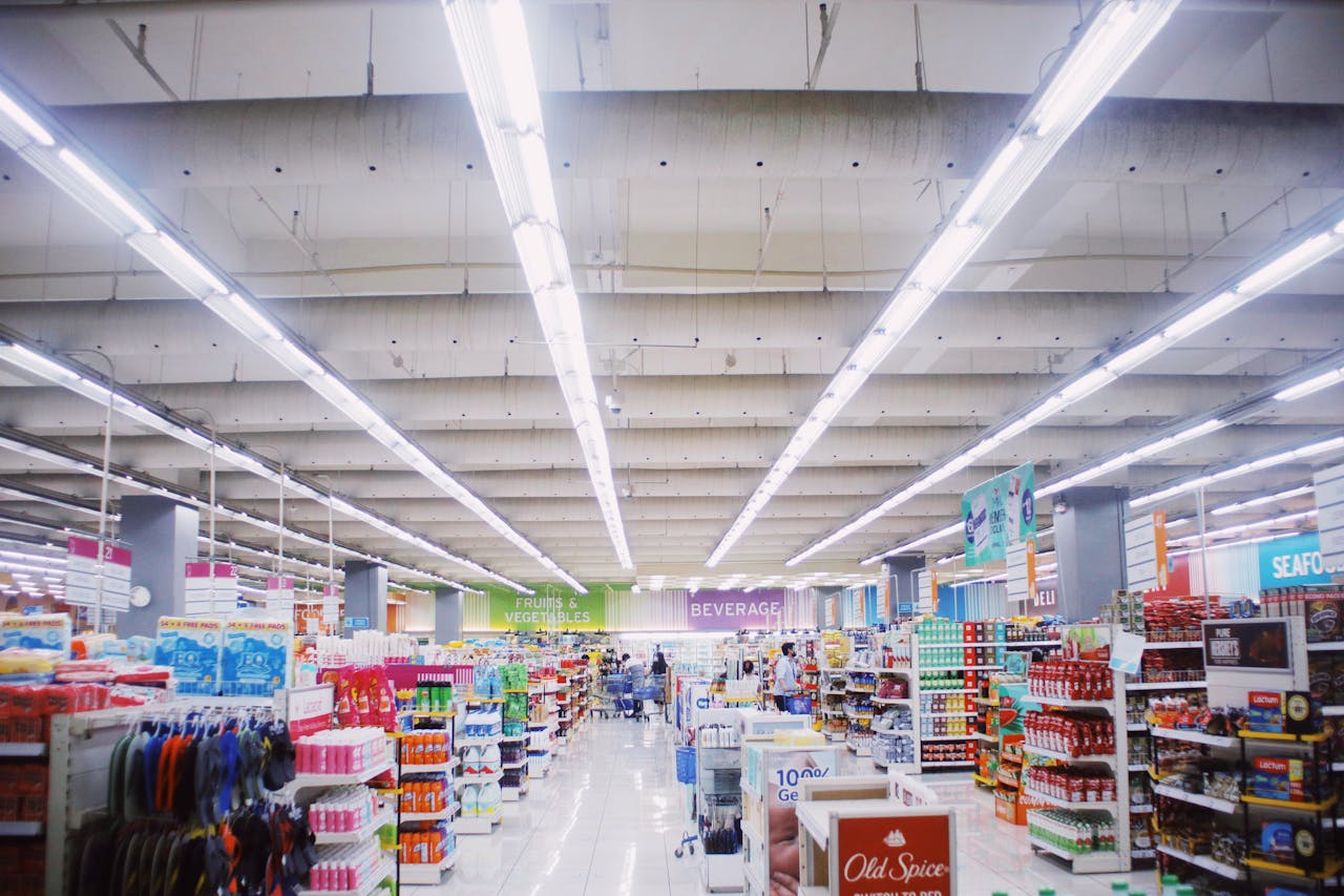 hero-img-02 Interior of modern supermarket with various shelves with assorted colorful products under bright lamps